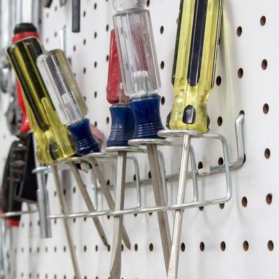 Screwdrivers hanging on a white pegboard