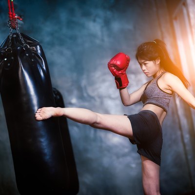 Young Woman Practicing Boxing In Gym