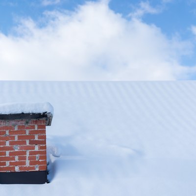 Chimney roof house under winter snow