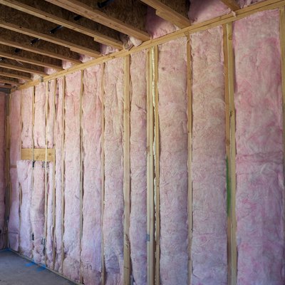 Wall of pink insulation in house