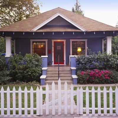 Small craftsman bungalow with picket fence.