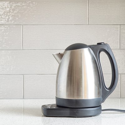 Electric stainless steel kettle on a granite counter top