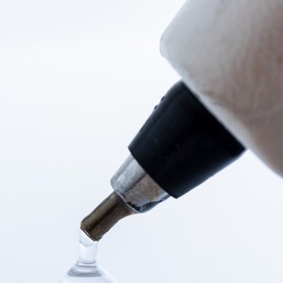 Close-Up Of Glue Dripping Against White Background