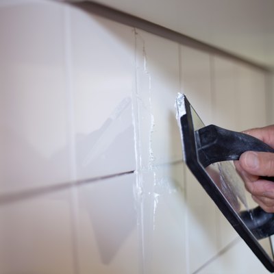 A Kitchen Fitter, tiling the walls