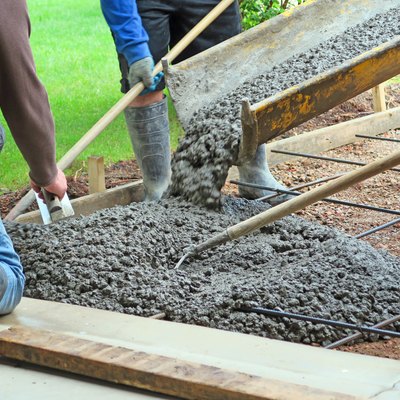 Make a concrete driveway- fresh cement from truck and workers