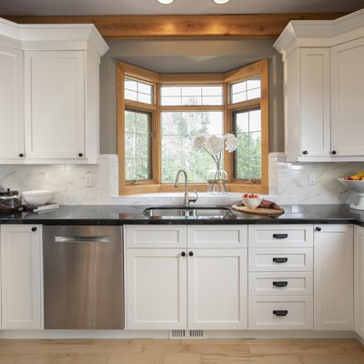 White home showcase interior kitchen with bay window over sink