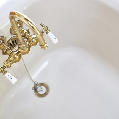 Vintage brass faucet in bathtub
