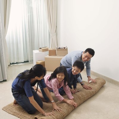 Family unrolling rug