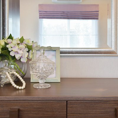 Jewery crystal jar with picture frame and flowers on table