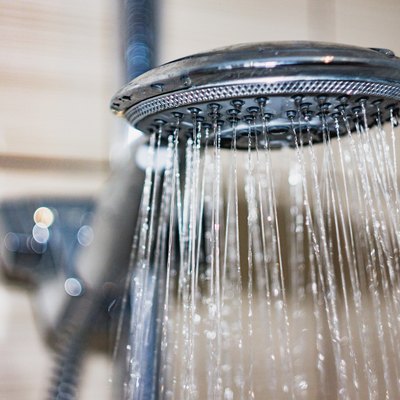 shower head with drops of water falling down