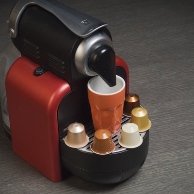 Nespresso coffee machine with capsules and cup