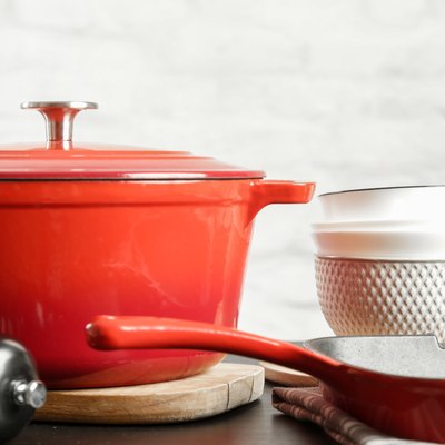 Cookware set: Red enameled cast iron pot, saucepan and bowls