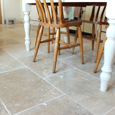 Image of filled travertine tile floor, kitchen table and chairs