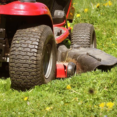 cutting the grass of on a tractor lawn mower