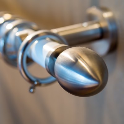 Stainless curtain rod on the wooden wall