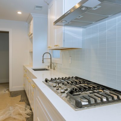 Stainless steel kitchen sink and modern kitchen interior with new oven kitchen in the apartment.