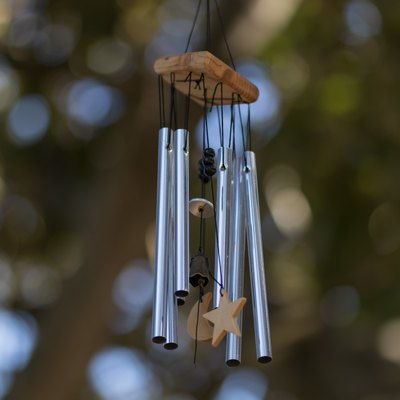 Close-Up Of Wind Chime Hanging Against Trees