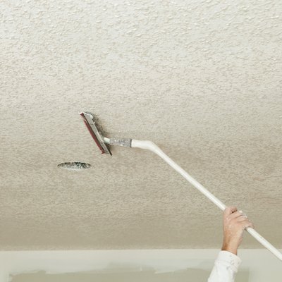 Worker Troweling Drywall Mud on a Ceiling for Knockdown Texture