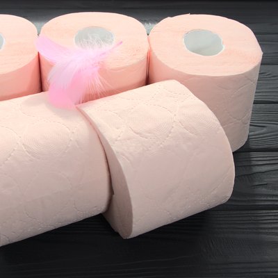 Pink toilet paper is on the table.