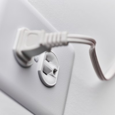 Close up of white plug in outlet