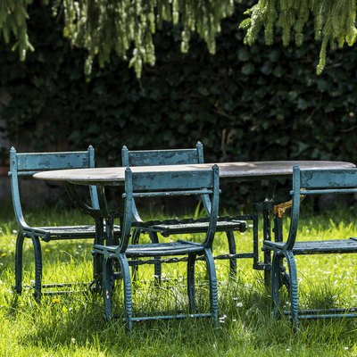 Old iron furniture in garden at springtime