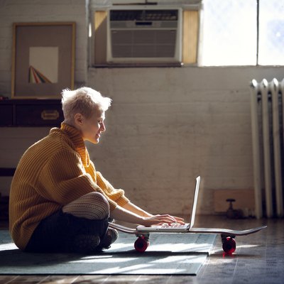 Woman using laptop computer while sitting at home