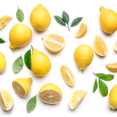 Ripe lemons and lemon leaves.