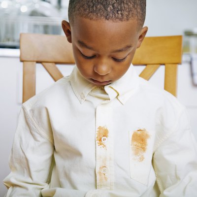 Young Boy Looking at Shirt's Food Stains