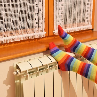Central heating radiator and woman in striped socks