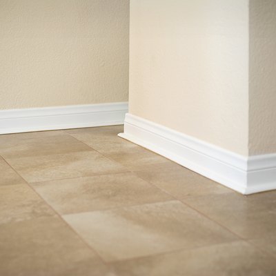 White baseboard along ceramic tile floor