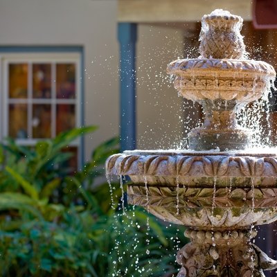 Two-tiered garden fountain flowing with water