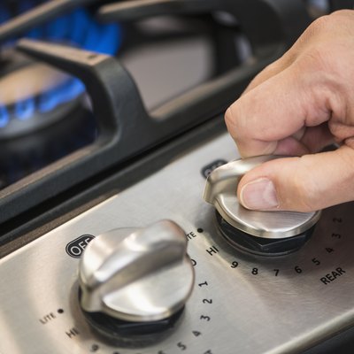 USA, New Jersey, Jersey City, Close-up of hand adjusting stove burner