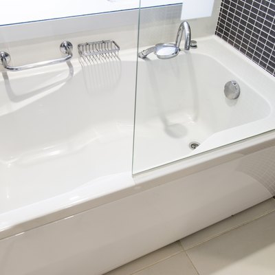 Bathtub with partial view of drain.