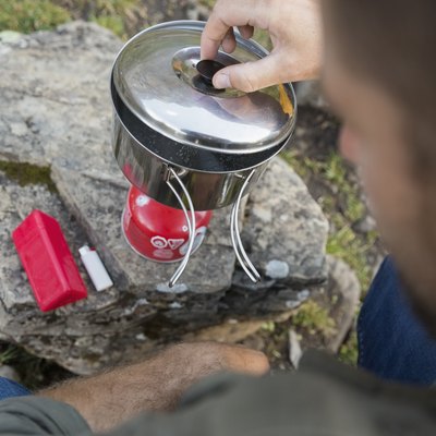 Close up man cooking with camping stove