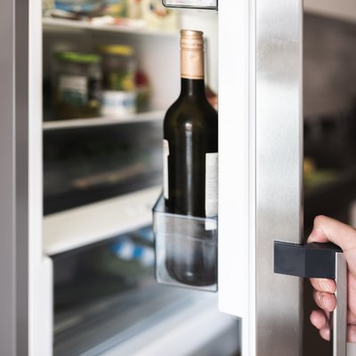 Cropped Hand Holding Refrigerator Door