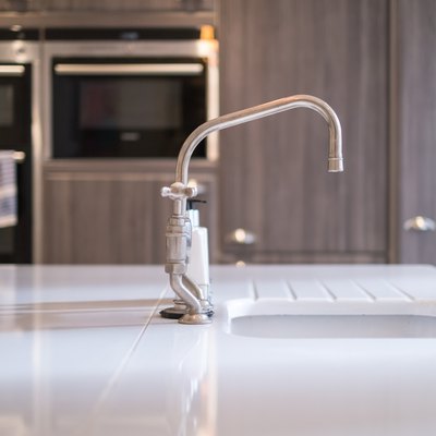 Kitchen Sink Against Cabinet At Home
