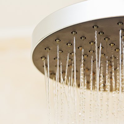 Looking up at a "rain shower" fitting, water running.