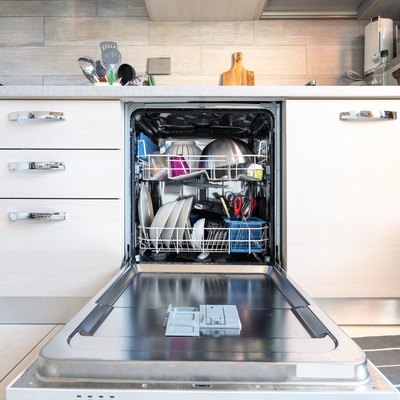Opened dishwasher with clean dishes