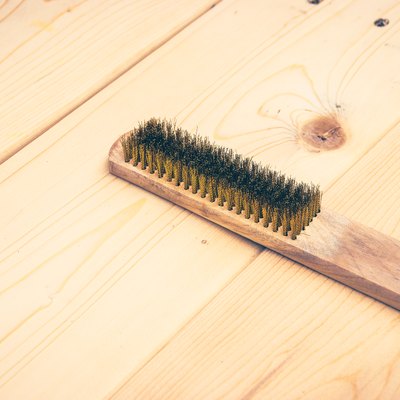 wire brush on wooden plank