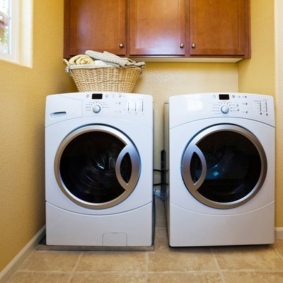 White modern washer and dryer in home's laundry room.