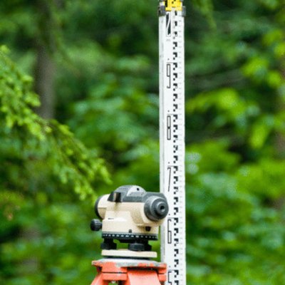 A transit and measuring stick are used to determine the grade or slope of land