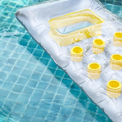 Inflatable swimming pool air mattress floating on clear swimming pool water