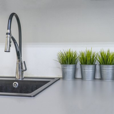 Kitchen sink and faucet in house interior.