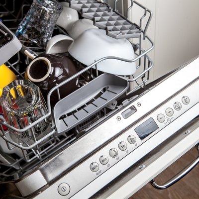 Clean dishes in dishwasher machine after washing cycle