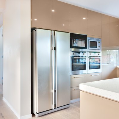 Modern refrigerator in the luxury kitchen with microwave ovens