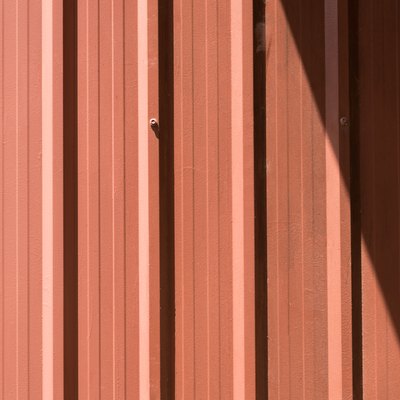 Brown corrugated metal sheet with bolts.