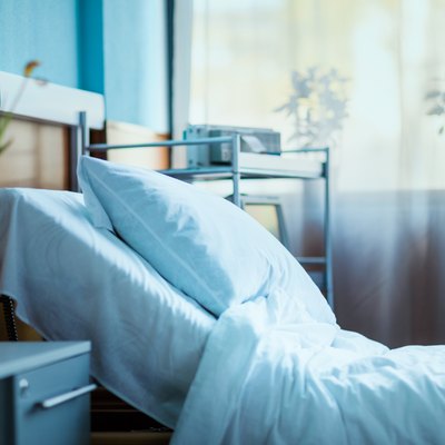 side view of empty hospital bed in clinic chamber