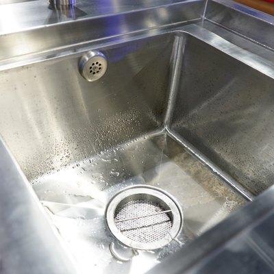Faucet in modern kitchen into sink