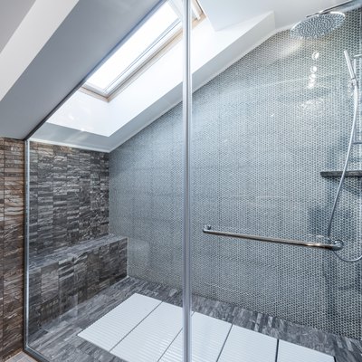 Glass shower cabin in modern loft bathroom