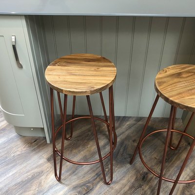 Image of curved kitchen floor cabinets painted duck egg blue, breakfast bar / kitchen island tongue and groove cladding timber, grey composite corian worktop countertop, oak wood stools with copper coloured metal legs on dark oak effect laminate floors
